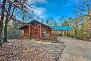 a cabin in the woods with a green roof at Pet-Friendly Cabot Cabin with Fenced Yard! in Cabot