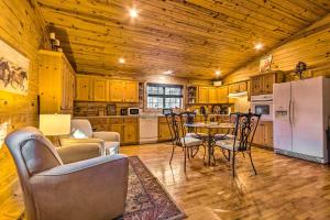 a kitchen with a table and chairs and a refrigerator at Pet-Friendly Cabot Cabin with Fenced Yard! in Cabot