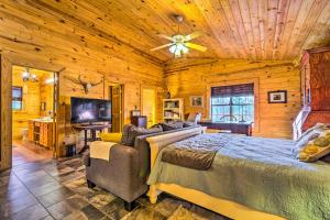 a bedroom with two beds and a flat screen tv at Pet-Friendly Cabot Cabin with Fenced Yard! in Cabot