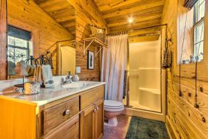 a bathroom with a sink and a toilet and a shower at Pet-Friendly Cabot Cabin with Fenced Yard! in Cabot