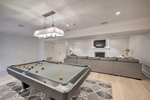 a living room with a pool table and a couch at Shelter Island Retreat with Outdoor Pool! in Shelter Island