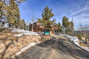 a house on the side of a snow covered road at Woodland Park Home with Stunning Mountain Views in Woodland Park