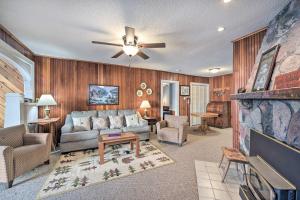 a living room with a couch and a ceiling fan at Spacious Home with Deck on Lake Chetek! in Chetek