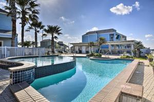 a swimming pool with blue water in front of a house at Pet-Friendly Port Isabel Home 5 Mi to Beach! in Port Isabel