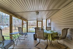 a screened porch with a table and chairs on it at Cozy Cottage Near Broyhill Walking Park! in Lenoir