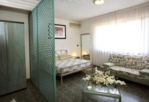 מיטה או מיטות בחדר ב-Hotel Residenza Delle Alpi