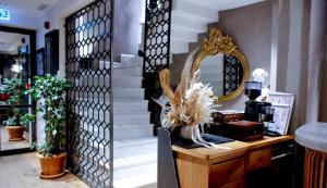 a dressing room with a mirror and a desk and stairs at Aleksandr Pera Hotel in Istanbul