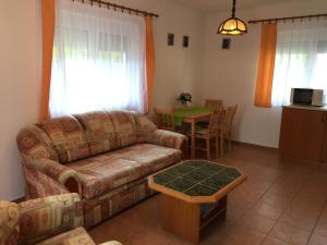 a living room with a couch and a table at Central Apartments in Zalakaros