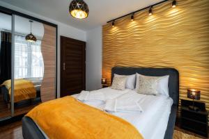 Posteľ alebo postele v izbe v ubytovaní Apartamenty Sun & Snow Resorts F Białka Tatrzańska z sauną