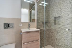 a bathroom with a sink and a glass shower at Lovely Central Apartment Guillem 3 Bedrooms Close To The Beach in Cala de Sant Vicent +23 photos