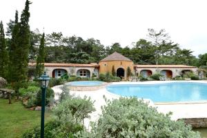 a house with a swimming pool in a yard at Moon River Village in Ban Bu Khanun