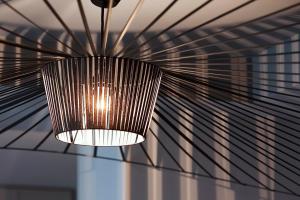 une lampe suspendue au plafond dans une pièce dans l'établissement Le Grey Hotel, à Paris