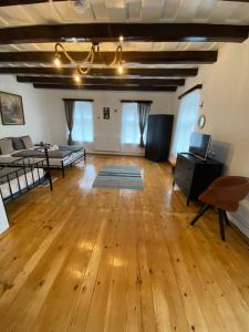 a large living room with wooden floors and a couch at Taverna Sasului in Bazna