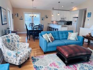 a living room with a blue couch and chairs at 2 the C in Holden Beach