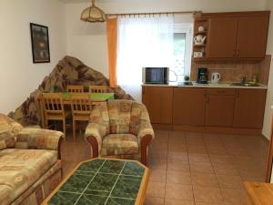 a living room with a couch and a table at Central Apartments in Zalakaros