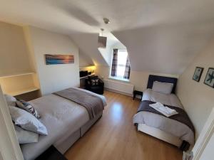 a bedroom with two beds in a attic at Spacious cosy apartment in Llandudno