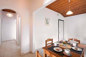 a dining room with a table and chairs in a room at Nissaki Sea View 201 by Sealand Villas in Nisakion