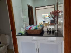 a bathroom with a counter with a basket on it at Seven Waves Beachfront Vacation Home, Bauang La Union 