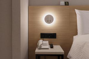 En eller flere senger på et rom på Hubhotel Benqiao Inn Far Eastern Branch