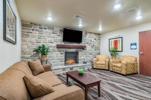 a living room with a couch and a fireplace at Cobblestone Inn & Suites - Lamoni in Lamoni