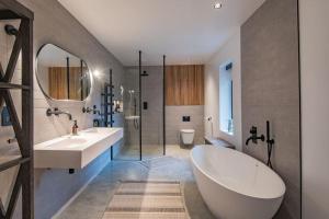 a bathroom with a large tub and a sink at The Barn in Sandwich