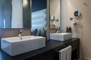 a bathroom with two sinks and a large mirror at E-GEO Easy Living Resort in Marmari