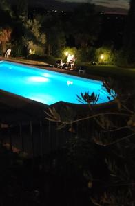 a swimming pool lit up at night at Agriturismo e Acetaia la Vedetta in Castelvetro di Modena