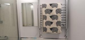 a bathroom with a shower curtain of black sheep at Peppercorn Pod at Beck House Glamping in Salmonby +48 photos