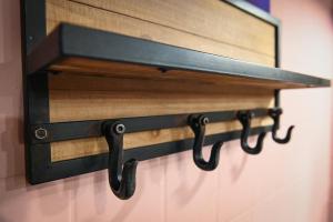 a mirror hanging on a wall with black metal brackets at Sleep Space 21 - Green Tiny Village Harz in Osterode