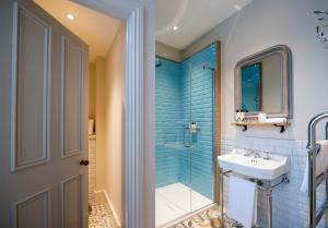 a bathroom with a sink and a shower at The Coach House in Potton
