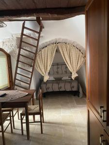a bedroom with a bunk bed with a ladder at Trulli Antichi Mestieri - Widespread Trulli in the historic center in Alberobello