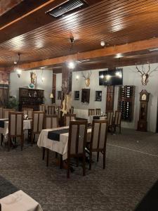 a restaurant with tables and chairs in a room at PENSIUNEA UNO in Timişoara