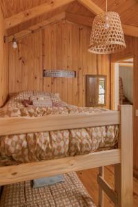 a bedroom with a bed in a wooden room at Nómada in San Martín de los Andes