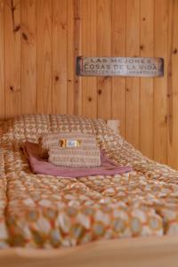 a bed with a blanket and a sign on the wall at B&B Casa Nómada in San Martín de los Andes +73 photos