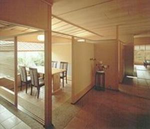 a dining room with a table and chairs in a room at Ise Todaya Ryoan in Ise