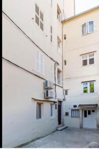 an alley between two buildings with a white building at Town Place Apartment in Split