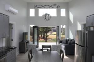 a kitchen and living room with a table and chairs at Golf Views Mount Airy in Mount Airy