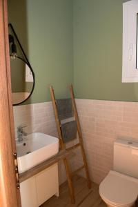 a bathroom with a sink and a toilet at Lila's villa maisonette with private pool in Nerotriviá