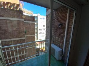 a balcony with a toilet and a view of a building at Live Like A Local In Bcn in Barcelona