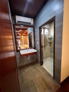 a bathroom with a sink and a mirror at Chaluenxay Boutique hotel in Luang Prabang