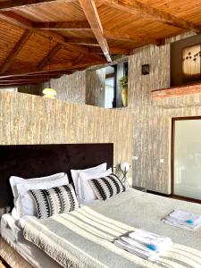 a bedroom with a large bed with white pillows at Penthouse Apartment 401 in Tbilisi City