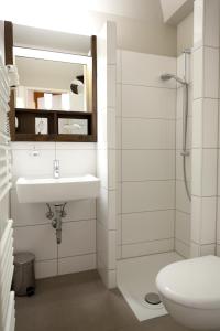 a bathroom with a sink and a shower at Hotel Weserschlösschen in Nienburg