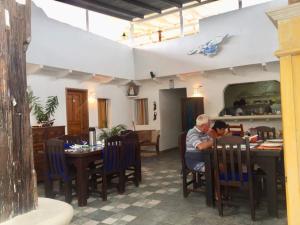 two people sitting at a table in a restaurant at Posada Guaripete in El Roque