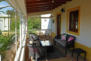 un porche cubierto con sillas y mesa en Vale do Guizo: Casa Poente on the contryside, close by the sea., en Aljezur