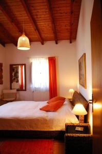 a bedroom with a large bed and a window at Vale do Guizo: Casa Poente on the contryside, close by the sea. in Aljezur