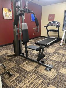 a room with a gym with a treadmill at Red Roof Inn & Suites Indianapolis Airport in Indianapolis