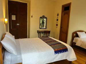 Giường trong phòng chung tại Mía Leticia