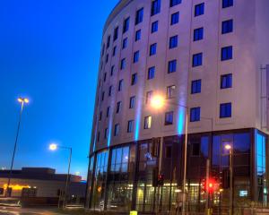 a building with blue lights on the side of it at Leonardo Hotel London Watford in Watford