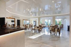 a dining room with tables and chairs in a building at Hotel Continent in Polyana