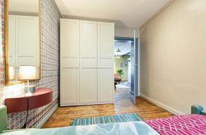 a bedroom with a bed and a cabinet and a hallway at Self check in Miera Art Apartment in Rīga